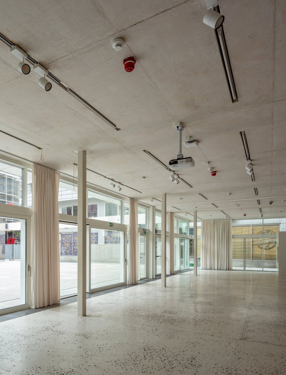 Zodiak- white concrete ceiling and terazzo floor with local stones from Vistula river